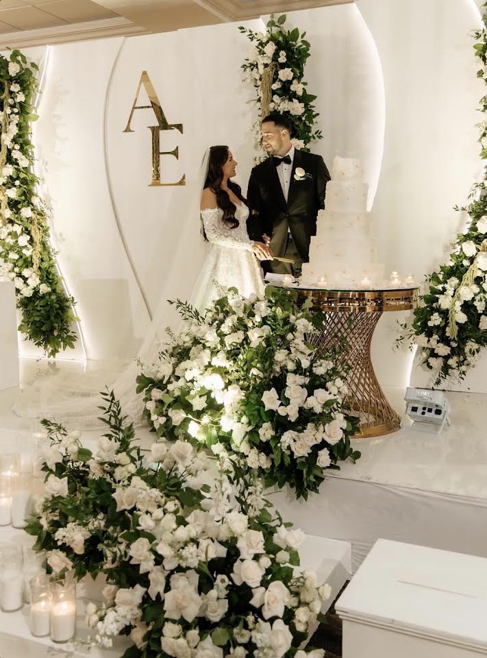 Cake cutting framed by white garden roses