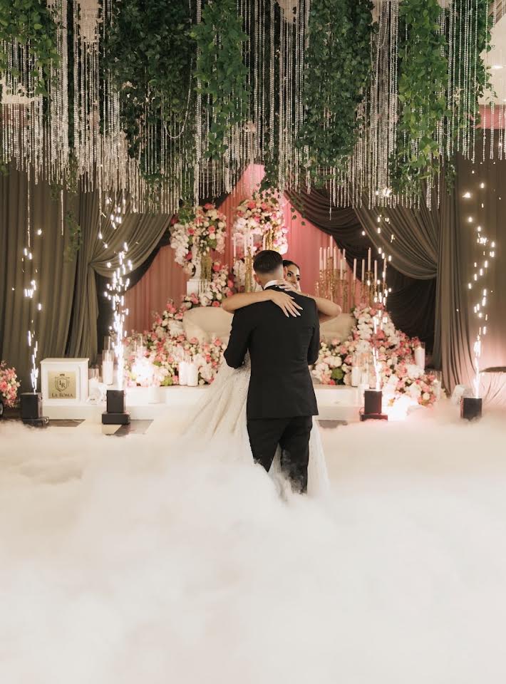 First dance in the clouds under cascading greenery