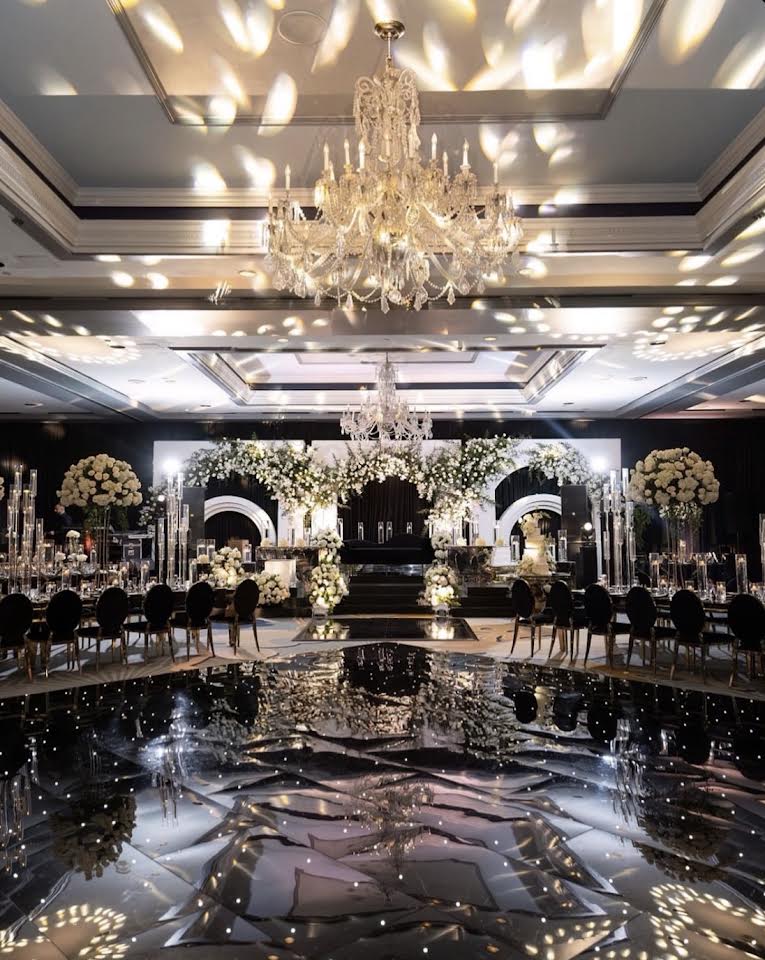 Ballroom with reflective dance floor and chandeliers